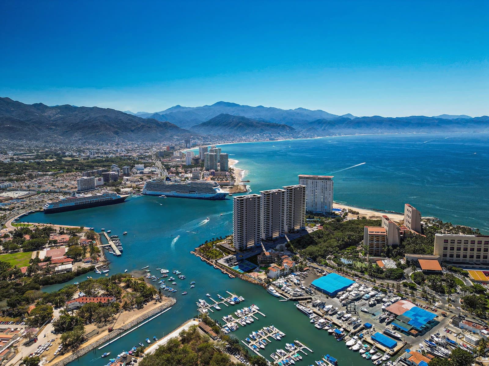 Aerial view of Marina Vallarta — the marina, golf course and Marina Towers on the bay