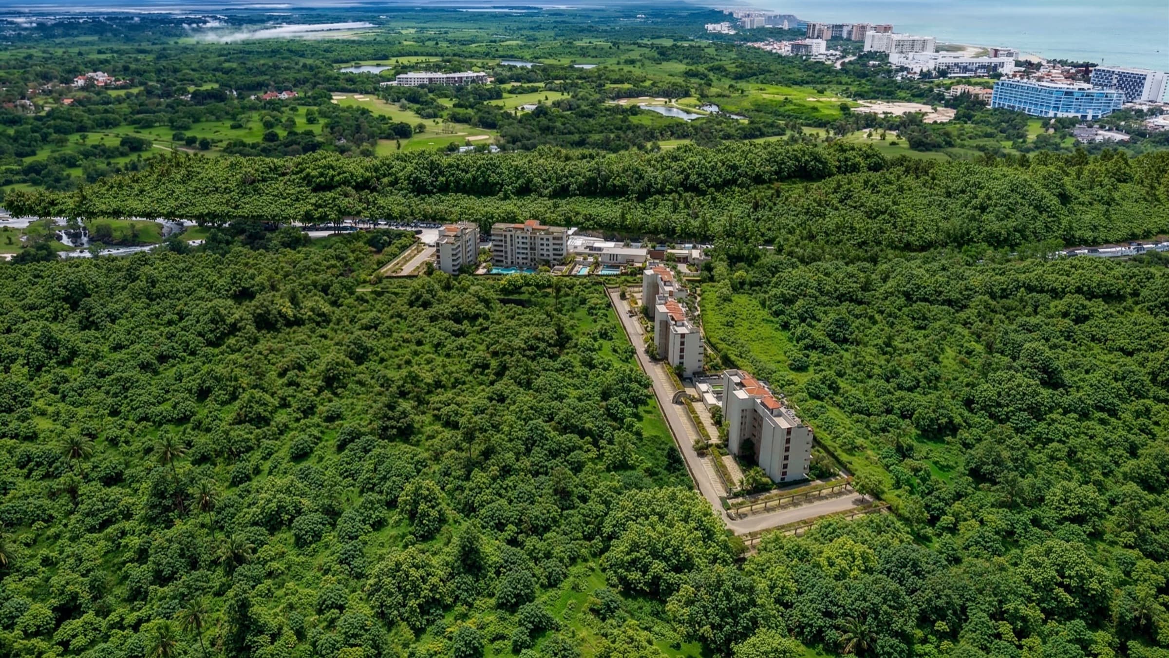 XUNA — five boutique towers in the green belt of Flamingos, Riviera Nayarit, with Flamingos Beach beyond